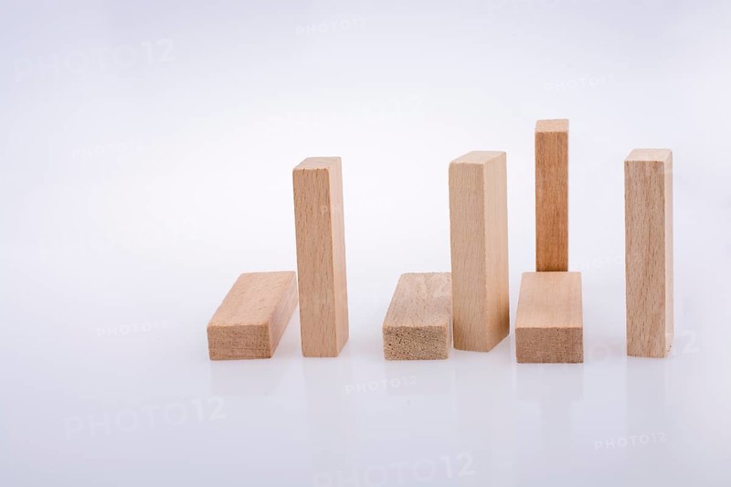 Wooden domino pieces positioned on white background