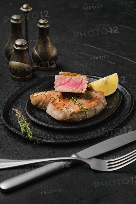Fried tuna steak on a stone plate