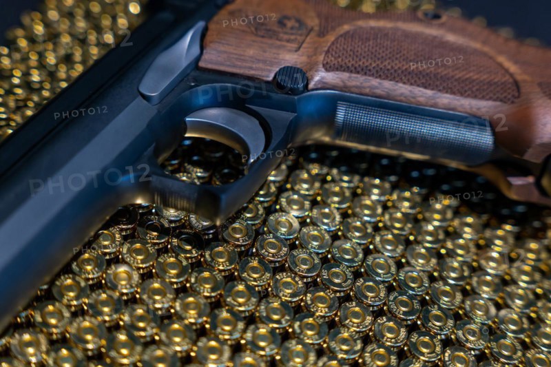 Elegant Semiautomatic 9mm Handgun with Swiss Helvetia Symbol Leaning on Bullet Ammunition in Switzerland