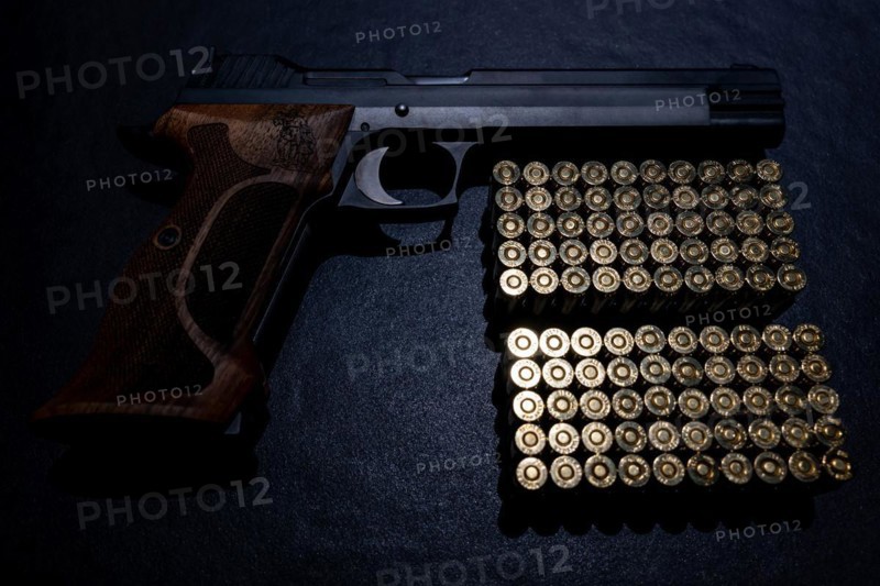 Elegant Semiautomatic 9mm Handgun with Swiss Wilhelm Tell Symbol Leaning with Bullet Ammunition in Switzerland