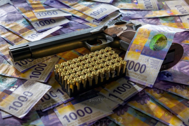 Elegant Semiautomatic 9mm Handgun with Swiss Helvetia Symbol Leaning on Swiss Franc 1000 Banknote and Bullet Ammunition in Switzerland