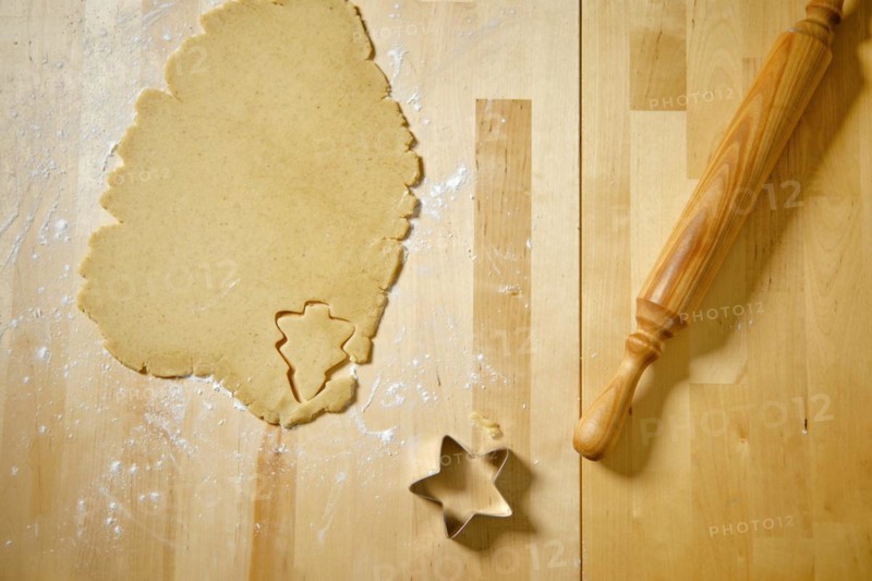Top view of kitchen table with rolled out cookie dough