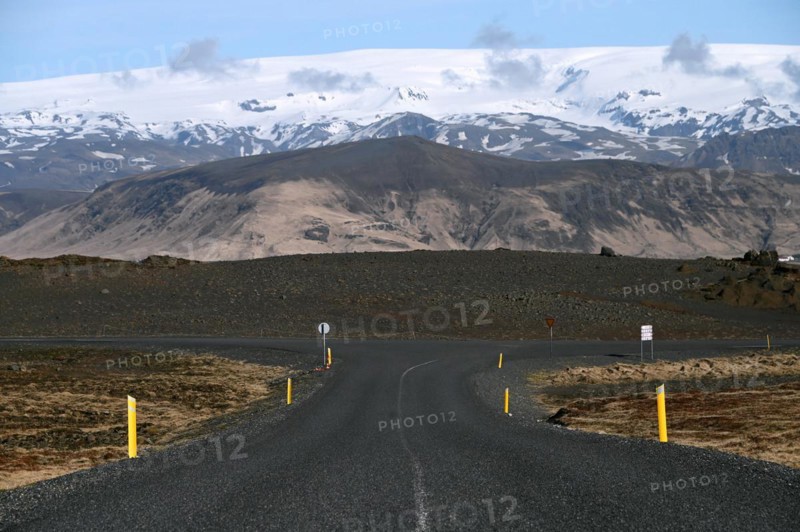 Road to the small peninsula of Dyrholaey on the south coast with a view of the glacier Myrdalsjoekull