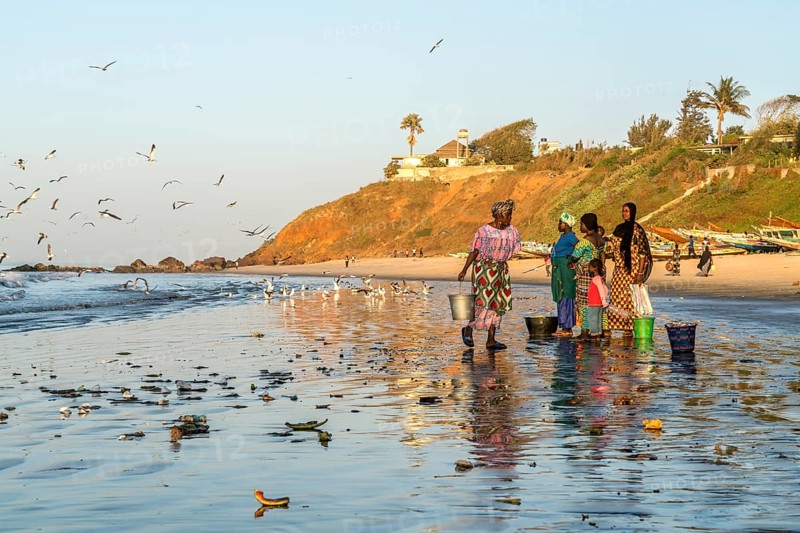 Fishermen's wives on the beach at the fish market