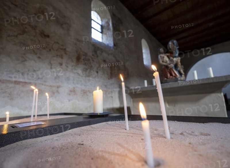 Candles in front of a Pieta in the side aisle of the Minster of St. Mary and St. Mark