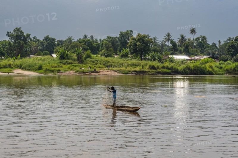 Fisherman in his dugout canoe