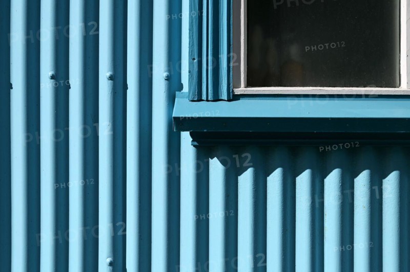 Detail of blue corrugated iron house cladding