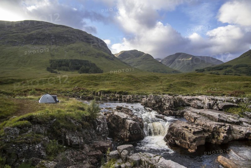 Wild camping with lightweight dome tent along the River Etive in Glen Etive near Glencoe in the Scottish Highlands