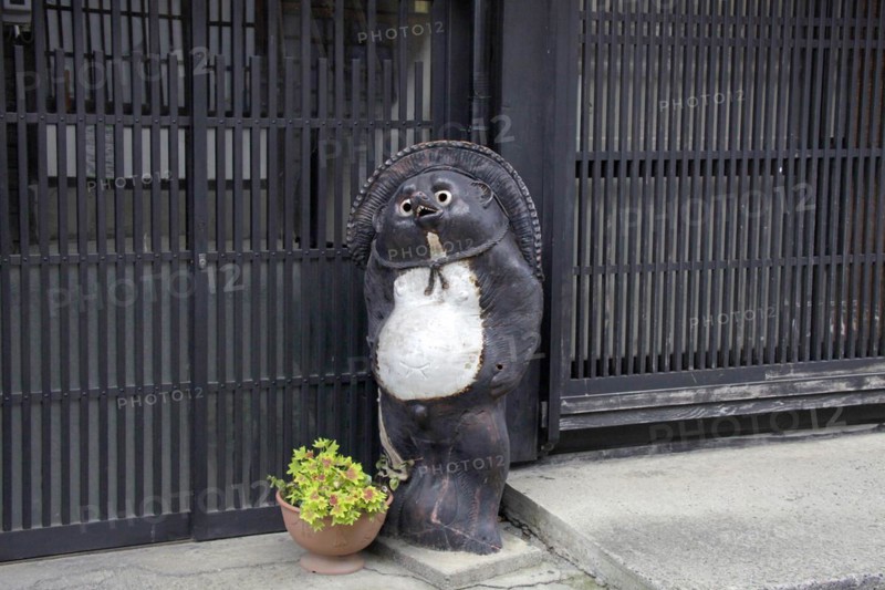 House front raccoon dog ornament at Narai-juku traditional small town in Nagano Japan
