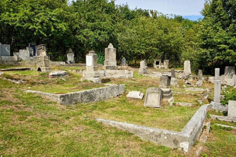 Overgrown and desolate burial ground at the dilapidated and abandoned cemetery in Horni Krupka