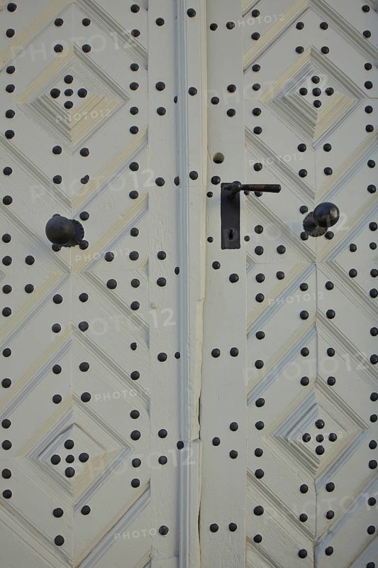 White house door from half-timbered house with fittings