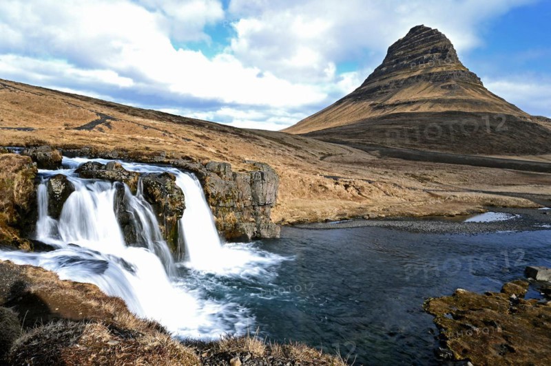Kirkjufellsfoss waterfall and Kirkjufell mountain on the north coast of the Snaefellsnes peninsula in western Iceland