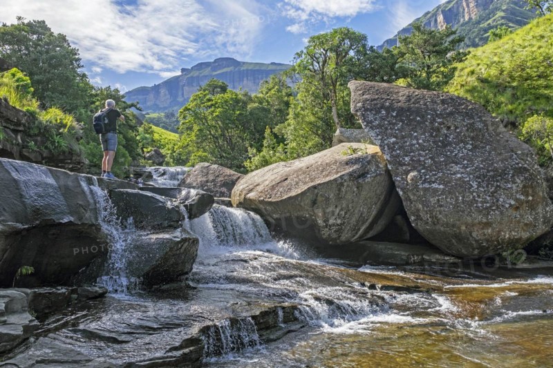 Western tourist visiting cascade in the Mahai River in the Royal Natal National Park