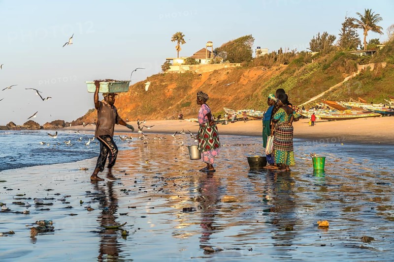 Fishermen's wives on the beach at the fish market