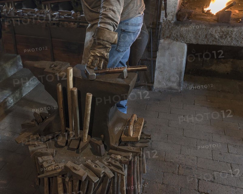 Anvil with forging hammers in a historic hammer mill from the 19th century