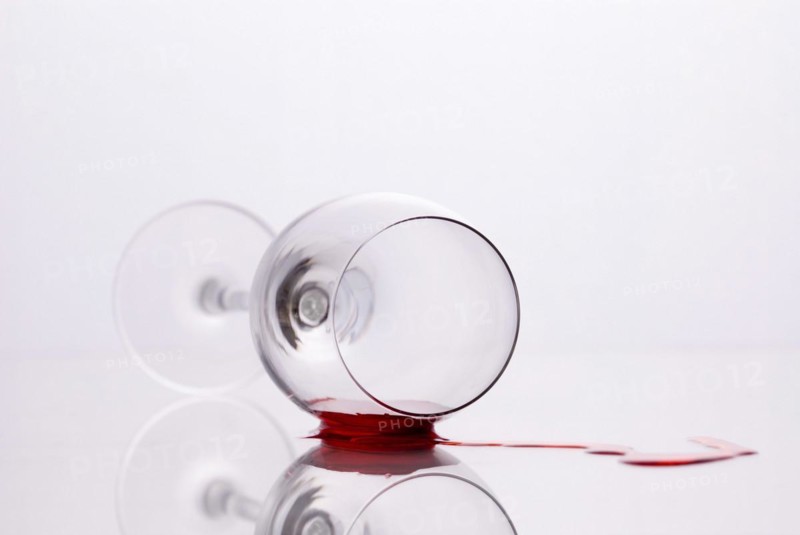 Red wine spilled out of fallen glass