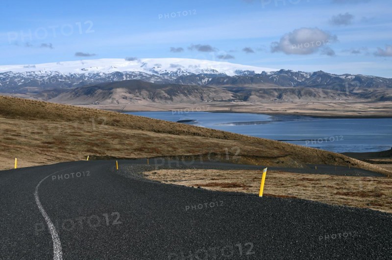 Road to the small peninsula of Dyrholaey on the south coast with a view of the glacier Myrdalsjoekull
