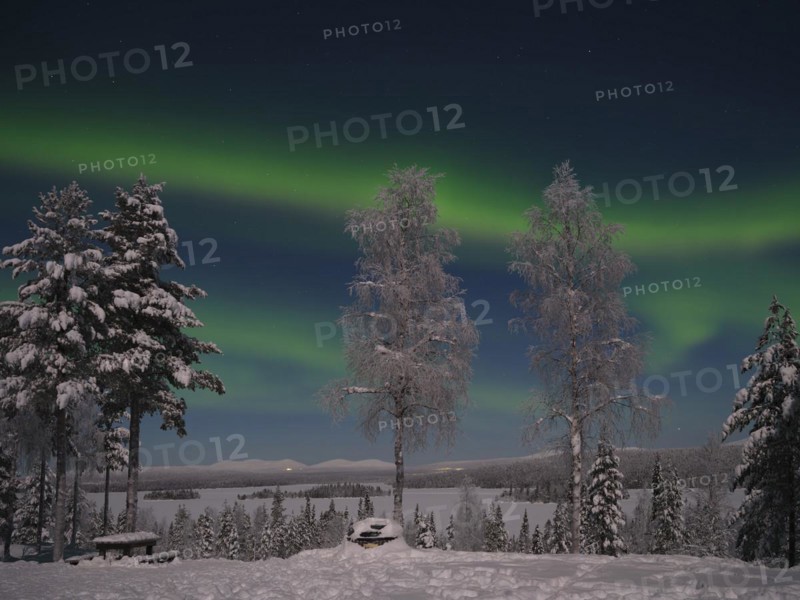 Northern Lights above Lake Saerkijaervi with a view of the mountains of Pallas Yllaestunturi National Park