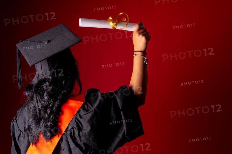 Female student in a graduation photo. End of education degree with graduate diploma. University