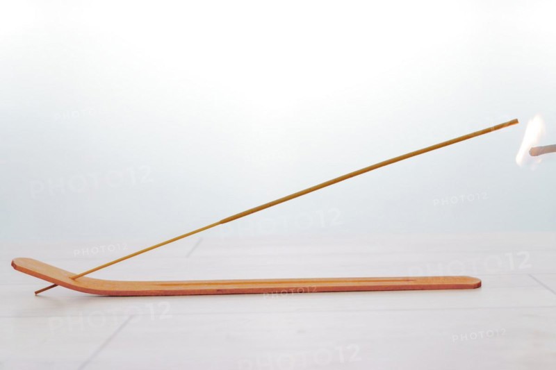 Close-up of an incense stick isolated on a white background