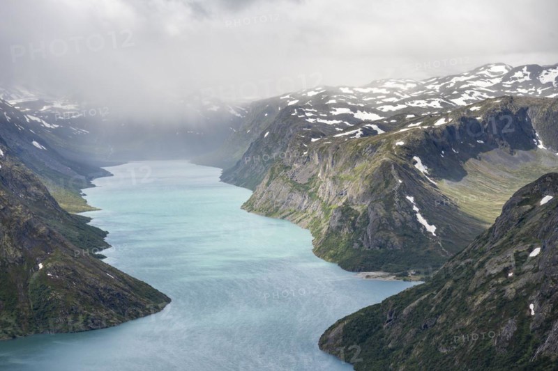 View of Lake Gjende and snowy mountains