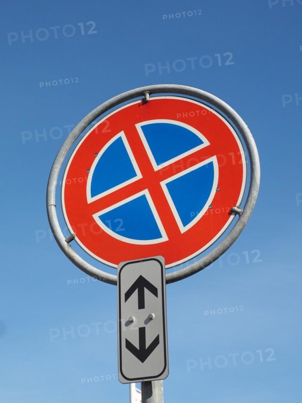No parking and no stopping sign over blue sky