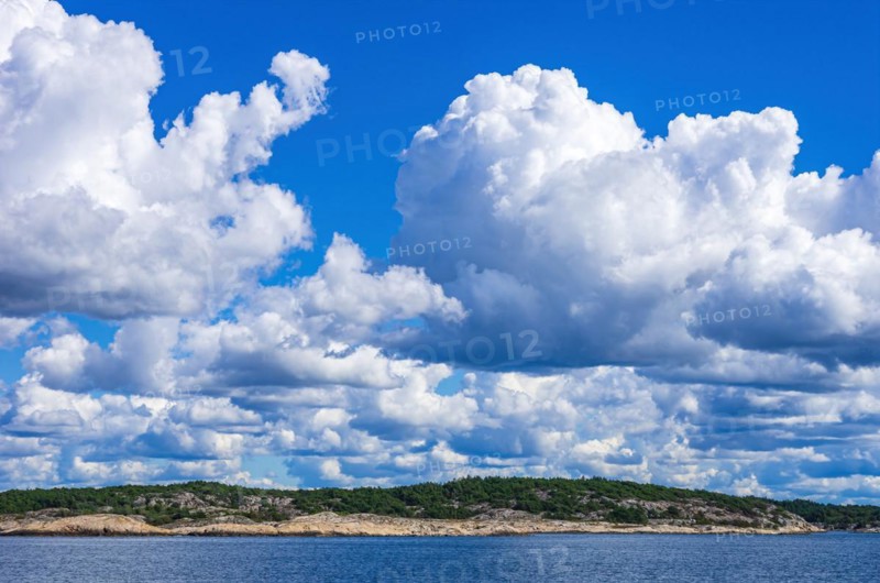 Archipelago and coastline under a wildly cloudy blue sky in the Kosterfjord between the Koster Islands and Stroemstad