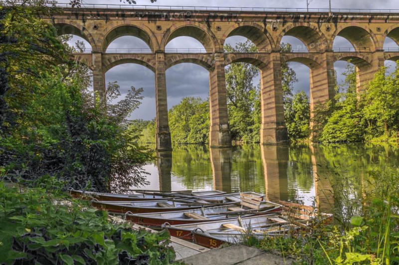 The railway viaduct Enzviaduct over the river Enz in the foreground floating boats in the town of Bietigheim-Bissingen