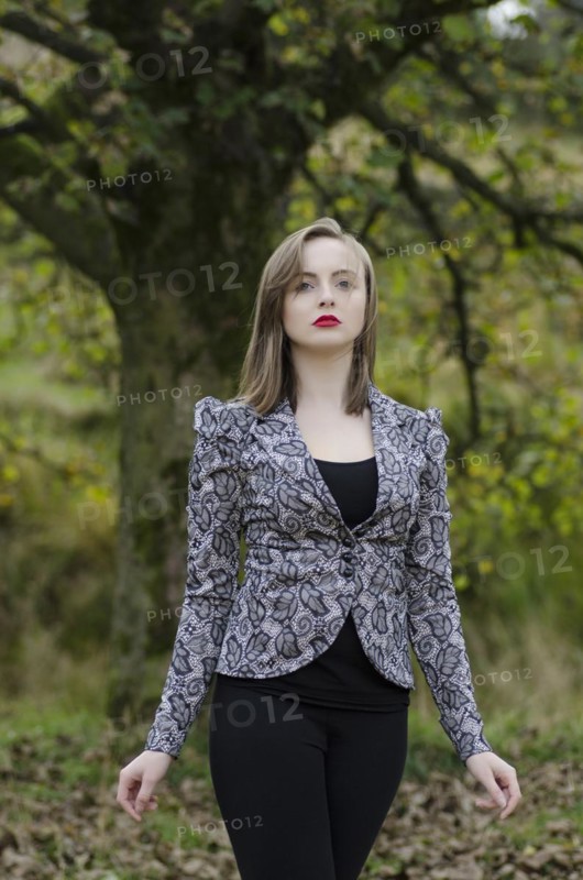 Beautiful young woman standing in the countryside