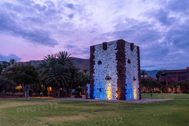 Beautiful park with the Torre del Conde illuminated at night in San Sebastian de La Gomera