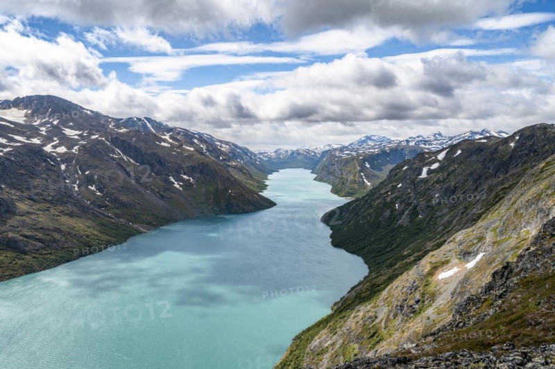 View of Lake Gjende and snowy mountains