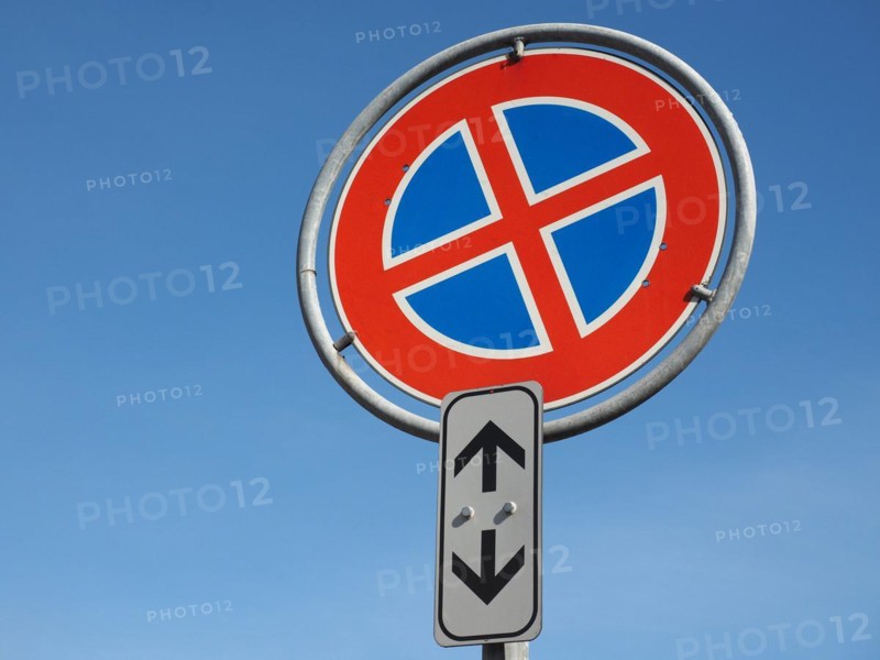 No parking and no stopping sign over blue sky with copy space