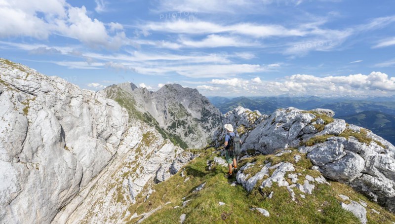 Mountaineer on a narrow ridge path
