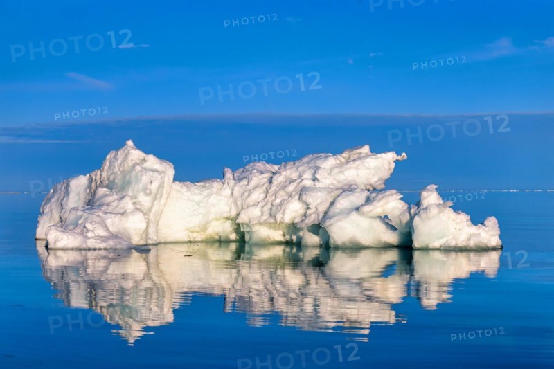 Melting Iceberg floating in the arctic sea