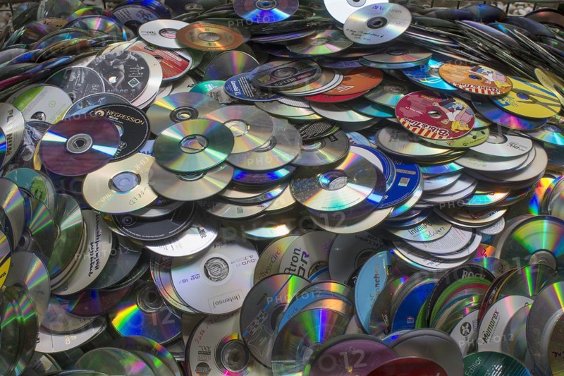 Old CD's collected for recycling in a container
