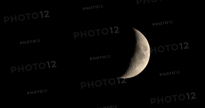 Waxing crescent moon seen with telescope