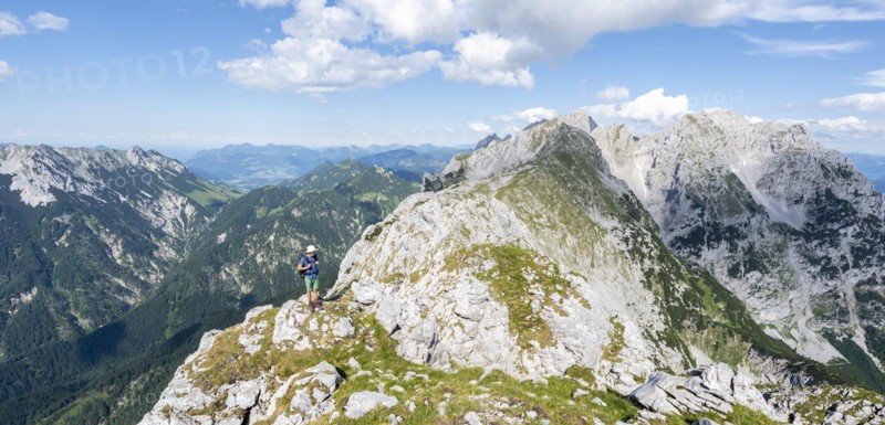 Mountaineer on a narrow ridge path