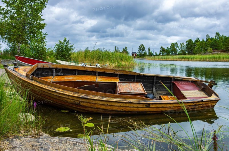 Small fishing boat at the edge of the lake
