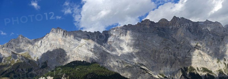 Play of light and shadow on the limestone mountain range of the Haut de Cry peak