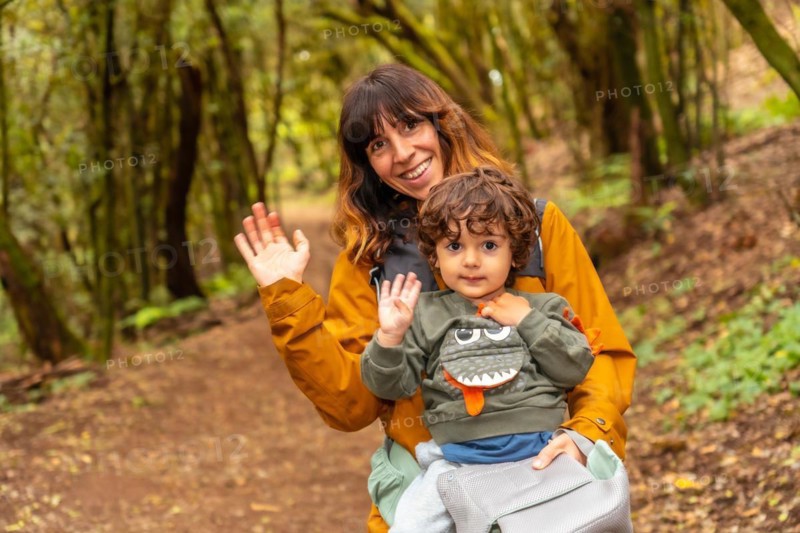 Mother and son having fun trekking on the trail in the mossy tree forest of Garajonay National Park