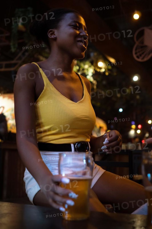 African woman in pub gather