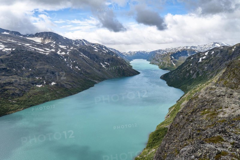 View of Lake Gjende and snowy mountains