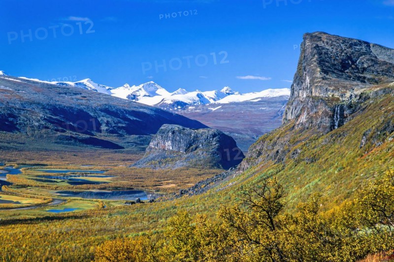 Landscape view with autumn colors and and snow capped mountains in Rapa valley in Sarek national park in Sweden