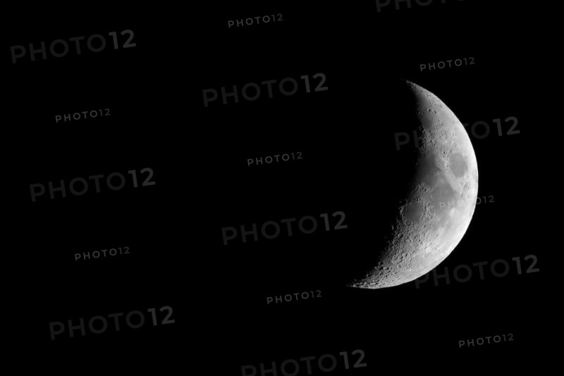 Waxing crescent moon seen with telescope