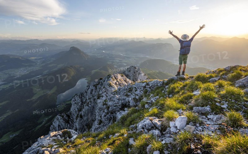 Mountaineer stretching his arms in the air