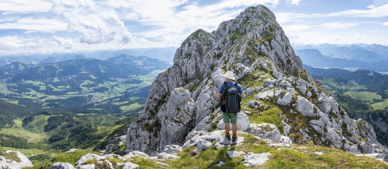 Mountaineer on a narrow ridge path