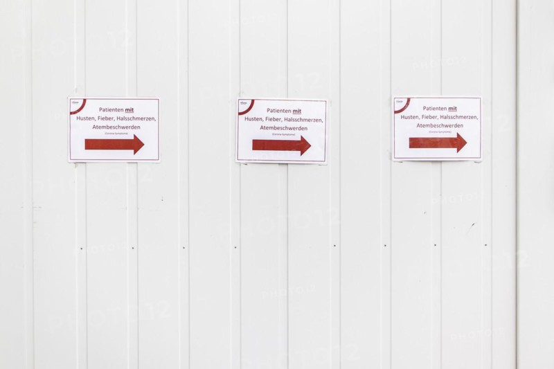 Three notices with the inscription 'Patients with cough