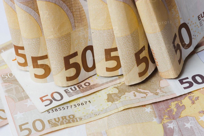 Symbolic photo on the subject of cash. 50 euro banknotes are held in one hand. Berlin