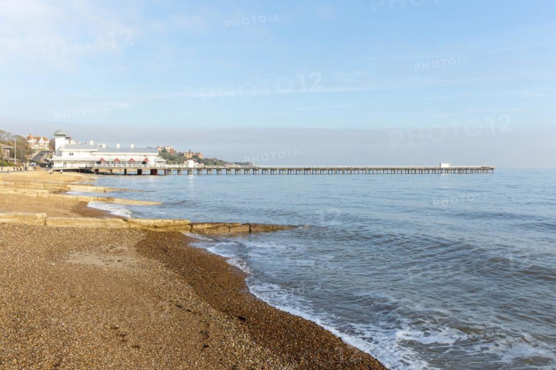 Groynes shingle beach and pier on seafront