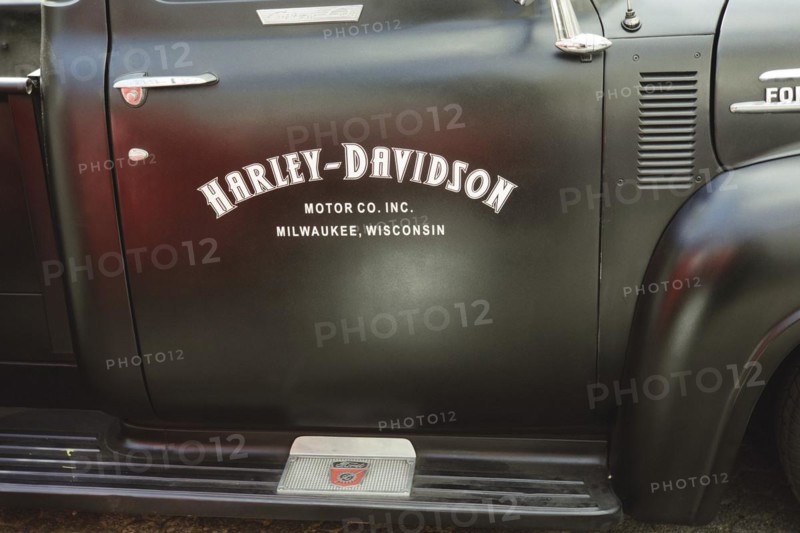 Advertisement for Harley Davidson on the car door of a 1953 Ford F100 V8